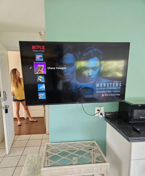 A television displaying a Netflix profile with the title "Monsters" and the subtitle "The Lyle and Erik Menendez Story". - Yonegan Maui Getaways - Haiku  (Haiku)