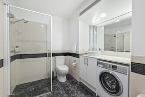 Separate bathtub and shower, towels, soap, shampoo