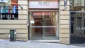 A building with a sign reading "the MET 11 Durham Street East".