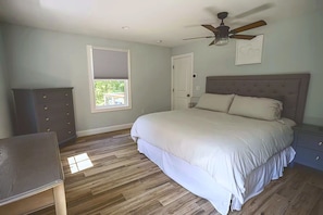 A bedroom with a bed, dresser, ceiling fan, and window. - North Conway Winter & Summer Retreat with Hot Tub & Fire Pit (Conway)