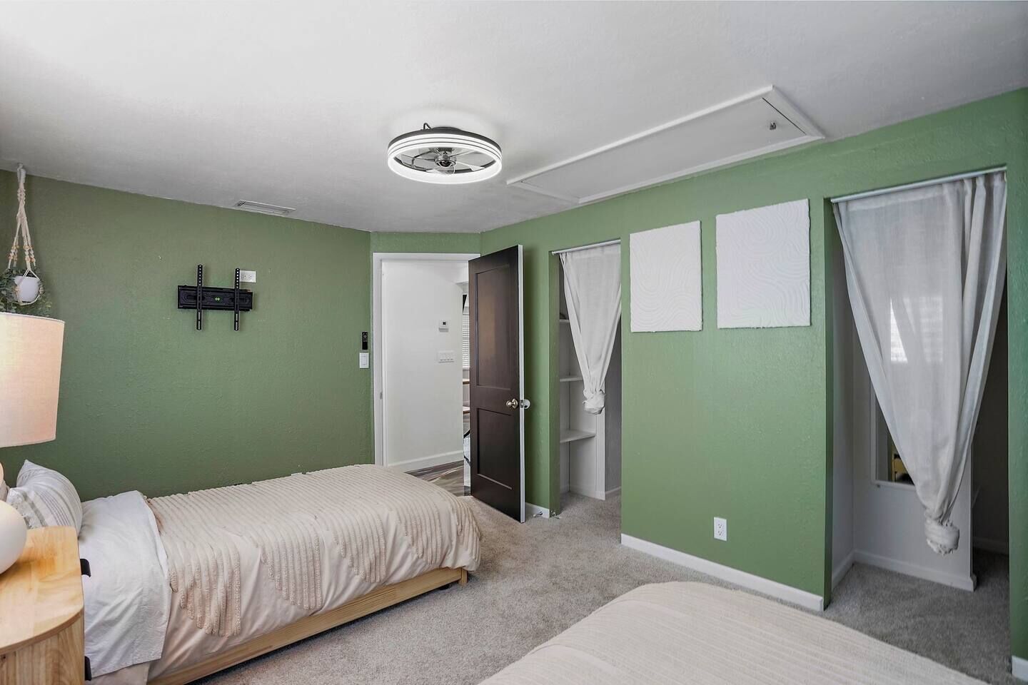 A bedroom with a bed, a desk, a chair, a wardrobe, and a closet.