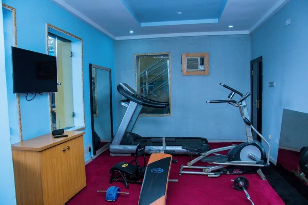 Ein Fitnessstudio mit Laufbändern, einem Ergometer und Gewichten.