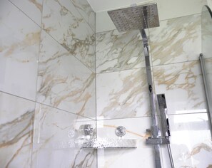 A shower with a handheld showerhead and a wall-mounted control panel. - Cozy, Family Friendly ,Home Away from Home in Aveley, Thurrock (Aveley)