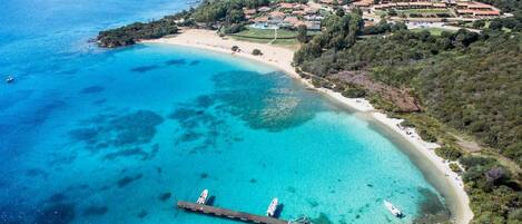 Una playa cerca, arena blanca, sombrillas, bar en la playa