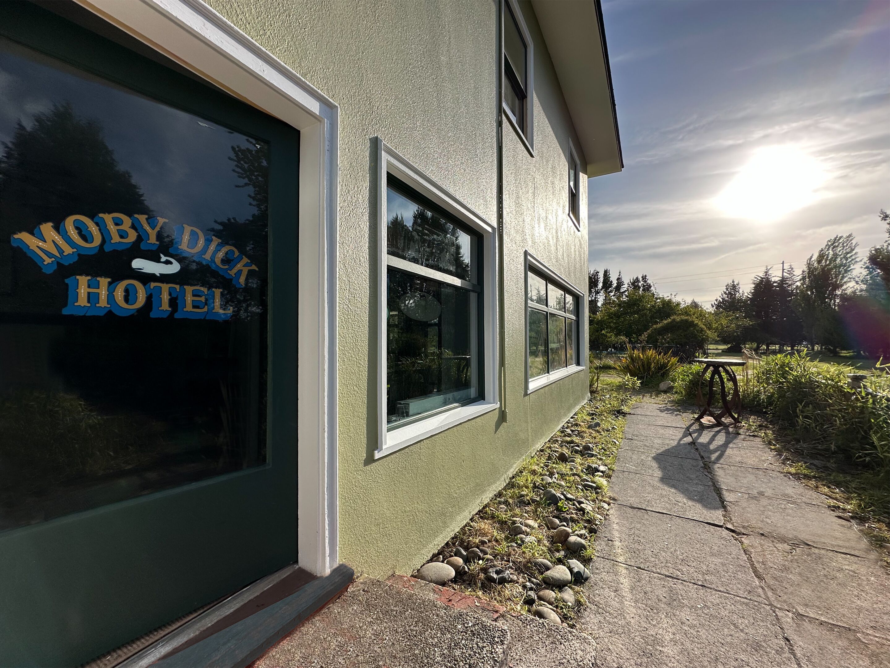 The exterior of the Moby Dick Hotel with a clear sky and sunlight.