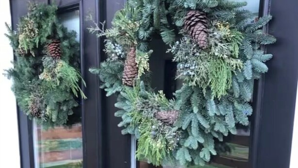 A front door with two wreaths, one on each door, and a glass door with a reflection of a garden. - Modern Studio in Terrific Portland with AC, WiFi (Portland)