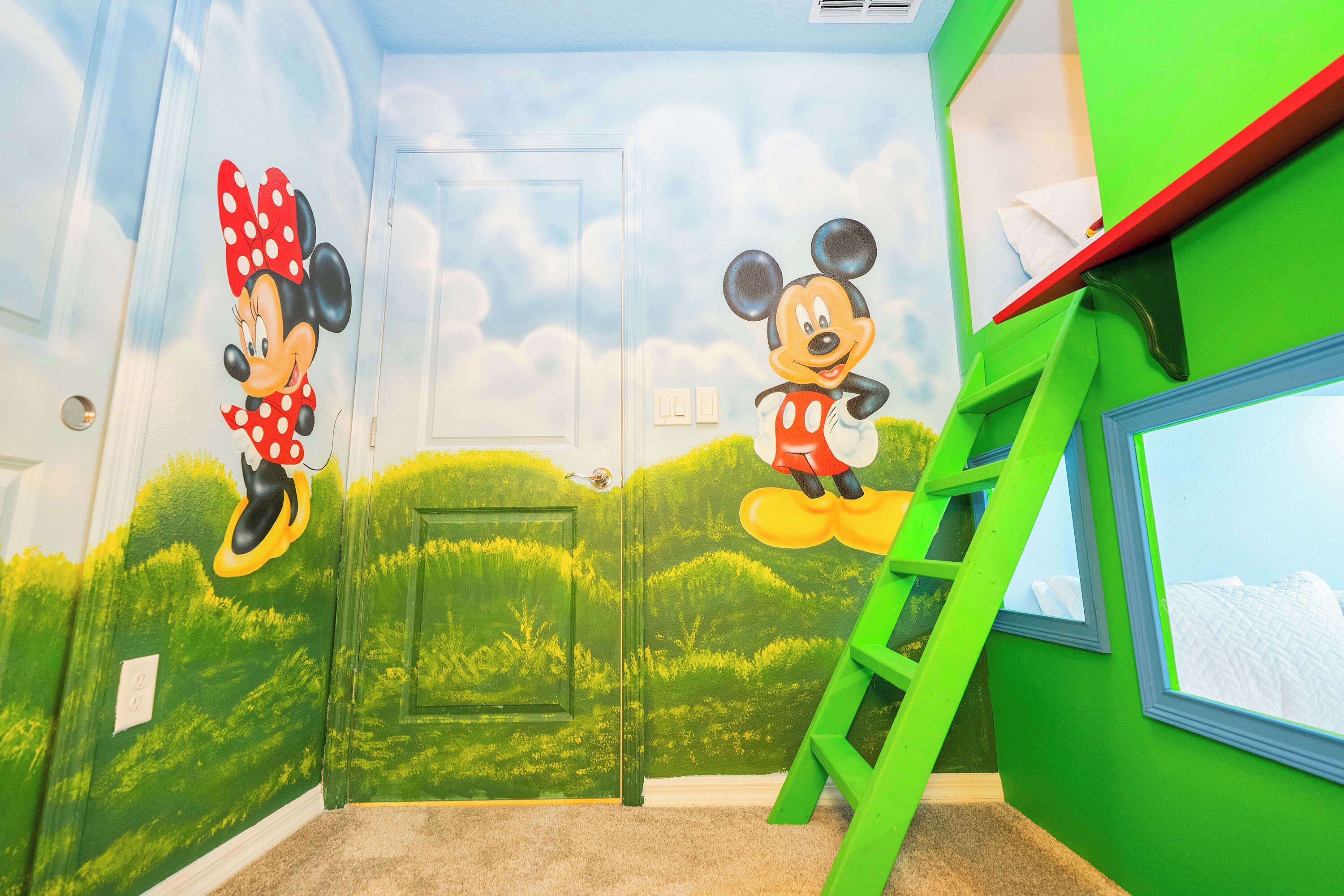 A room with green walls, a window, and a ladder.