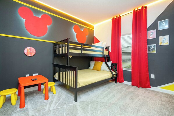 A bunk bed with a yellow mattress, a small orange table, and two yellow stools. - Stunning 4Bd W/ Pool @ Storey Lake 4239 (Kissimmee)