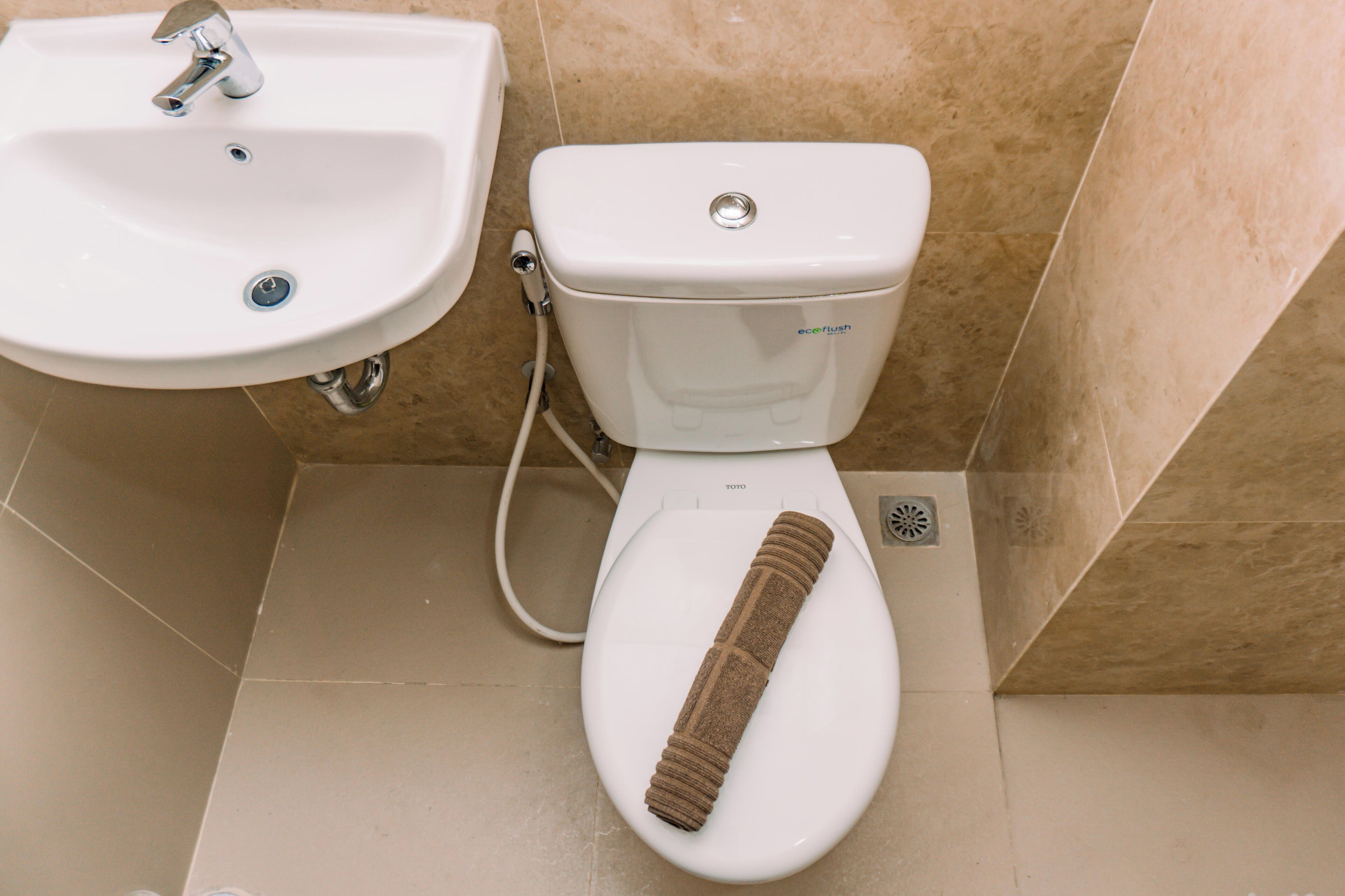 A bathroom with a white sink, a toilet, and a bidet.