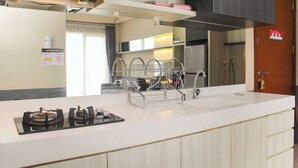 A modern kitchen with a white countertop, stainless steel appliances, and a dish rack. - Comfort And Cozy Living 1Br At Signature Park Grande Apartment (Jakarta)
