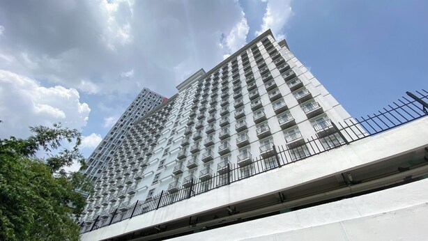 A high-rise building with multiple balconies and a modern architectural design. - Well Furnished And Cozy Studio Paltrow City Apartment (Semarang)