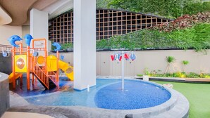 A children's play area with a pool, slides, and a climbing structure. - Modern Look And Nice Studio Transpark Bintaro Apartment (South Tangerang)