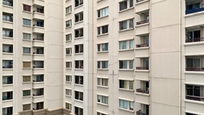 A high-rise building with multiple balconies and windows. - Homey And Modern 2Br At Marina Ancol Apartment (Jakarta)