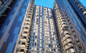 A high-rise building with multiple balconies and windows, likely a residential or hotel building. - Good Place And Homey 2Br At Podomoro City Deli Medan Apartment (Medan)
