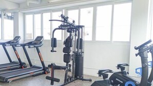 A gym with treadmills, a weight machine, and a stationary bike.