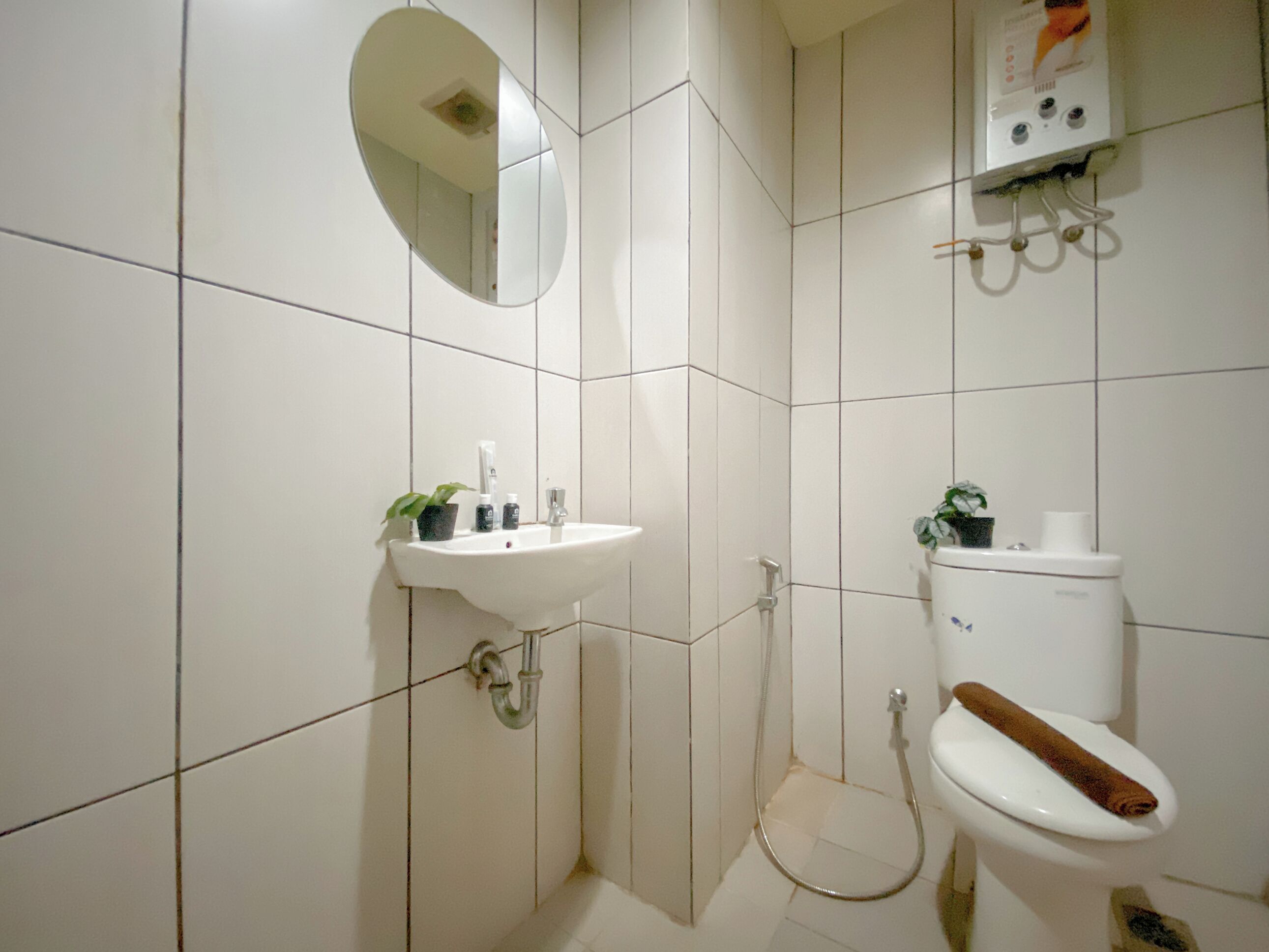 A bathroom with a sink, toilet, and shower.