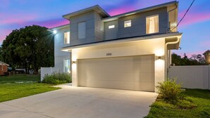 A modern two-story house with a garage, numbered 3105, and a well-maintained lawn.