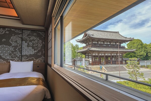 A hotel room with a large window overlooking a traditional Japanese building. - Kyoto Omuro Kadensho（Kyoritsu Resorts）- Adults only (Kyoto)