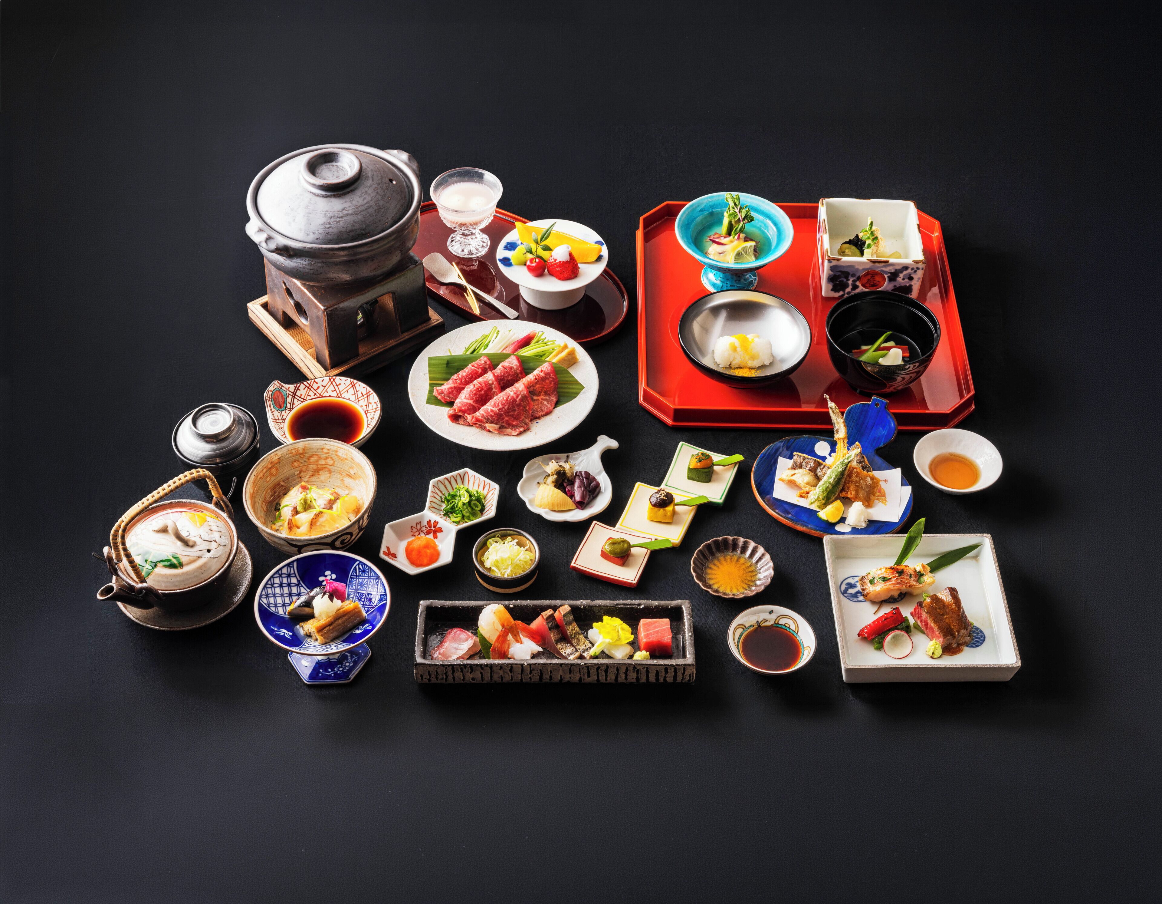 A variety of Japanese dishes and drinks arranged on a table.