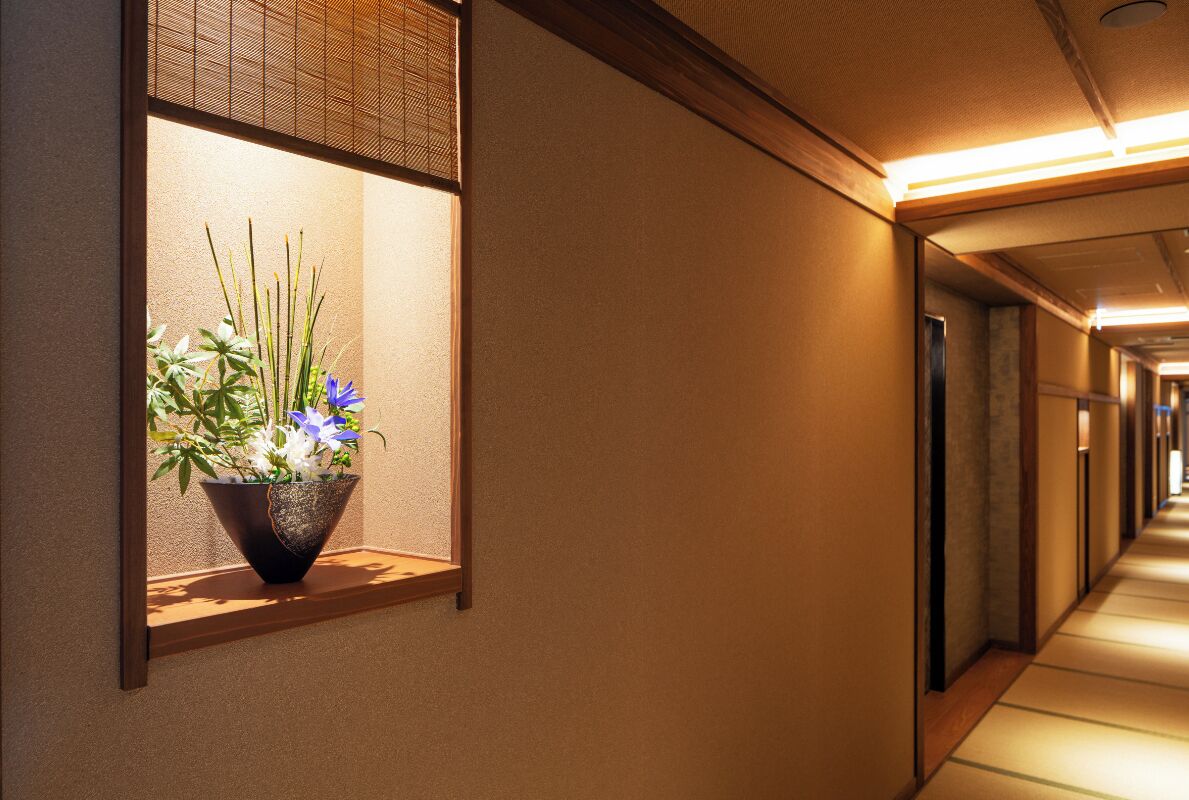A hallway with a window displaying a plant.