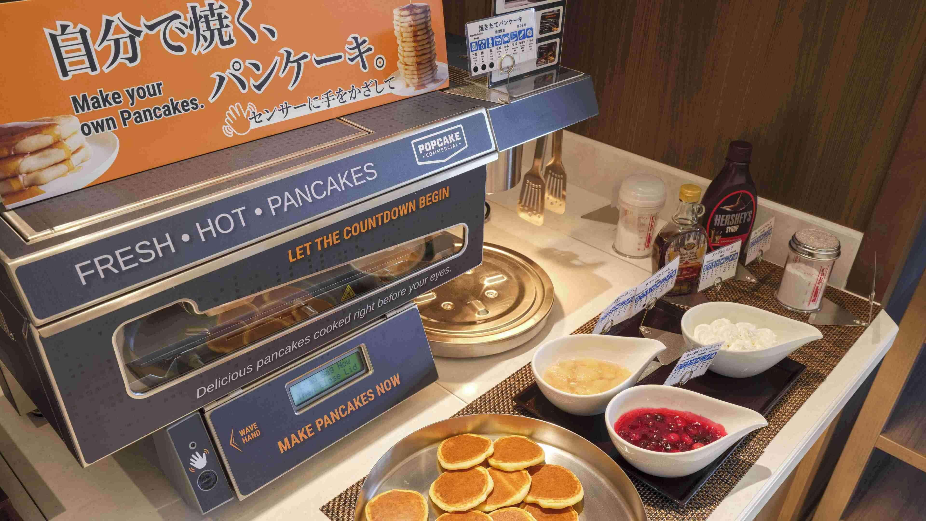 A self-service pancake station with instructions and fresh ingredients.