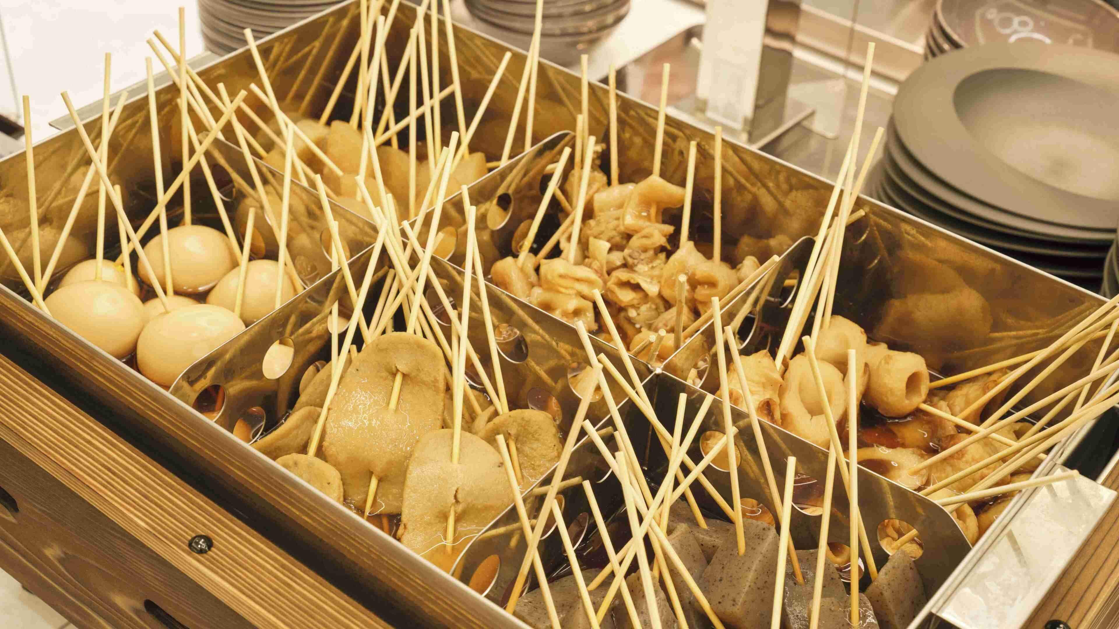 A tray with skewers of food items, likely for a buffet or communal meal setting.