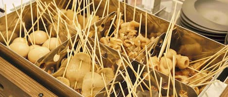 A tray with skewers of food items, likely for a buffet or communal meal setting.