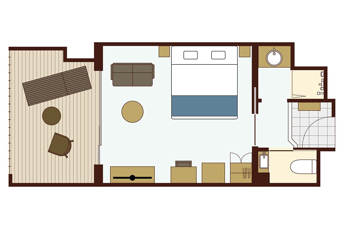 A hotel room layout with a bed, sofa, two chairs, a small table, a desk, a wardrobe, a bathroom with a sink, toilet, and bathtub.
