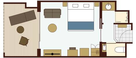 A hotel room layout with a bed, sofa, two chairs, a small table, a desk, a wardrobe, a bathroom with a sink, toilet, and bathtub.