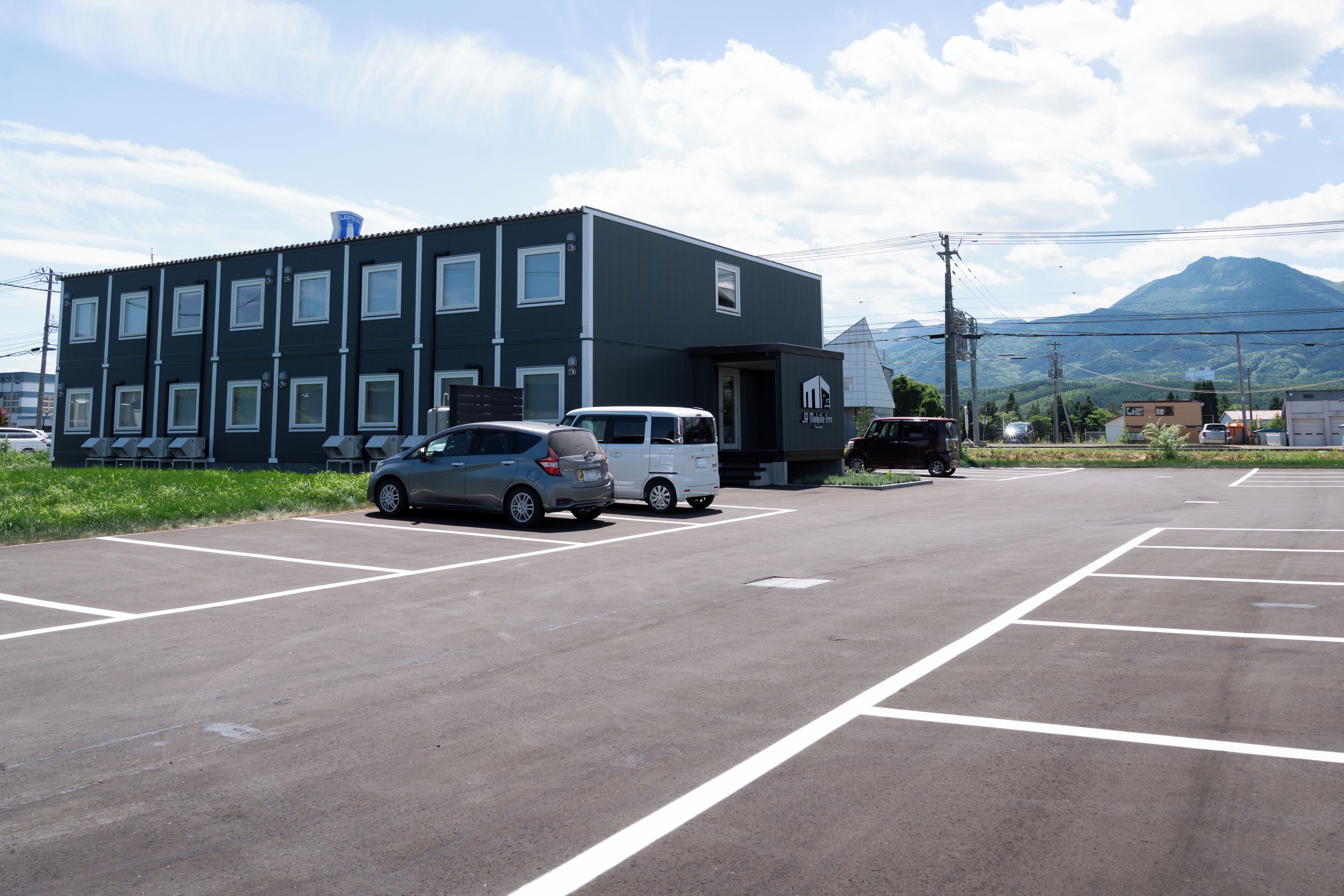 A parking lot with a building in the background.