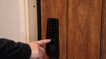 A person using a numeric keypad on a door lock.