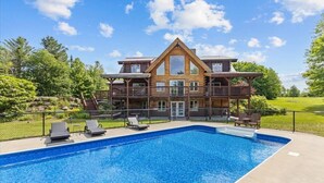 A large wooden house with a swimming pool and outdoor seating. - Three Peaks Retreat: Pool, Hot Tub & Fireplace (Hyde Park)
