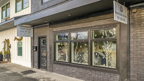 A building with a sign for 'North Light Salon & Spa' and 'Serenity Skin by Sonia'. - Harbor Hub Retreat | Walk to Tours & Dining (Juneau)
