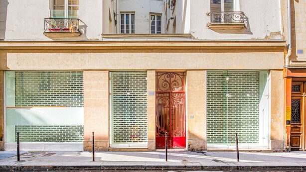 A building with three large windows, a central door with intricate metalwork, and balconies with metal railings. - Blueground | Sainte-Avoye, view, nr Le Marais (Paris)