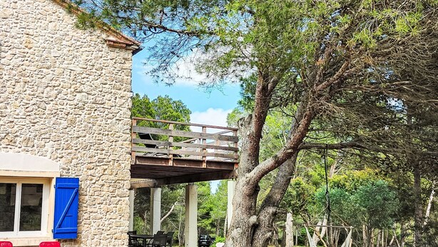 A stone building with a balcony, outdoor seating, and a hammock. - Mas de Caussagues by Interhome (Sigean)