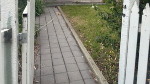 A house with a front porch, a visible door, and a small garden area. - Awesome Central Horsham Home (Horsham)