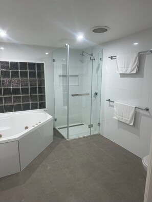 Shower, jetted tub, towels, soap