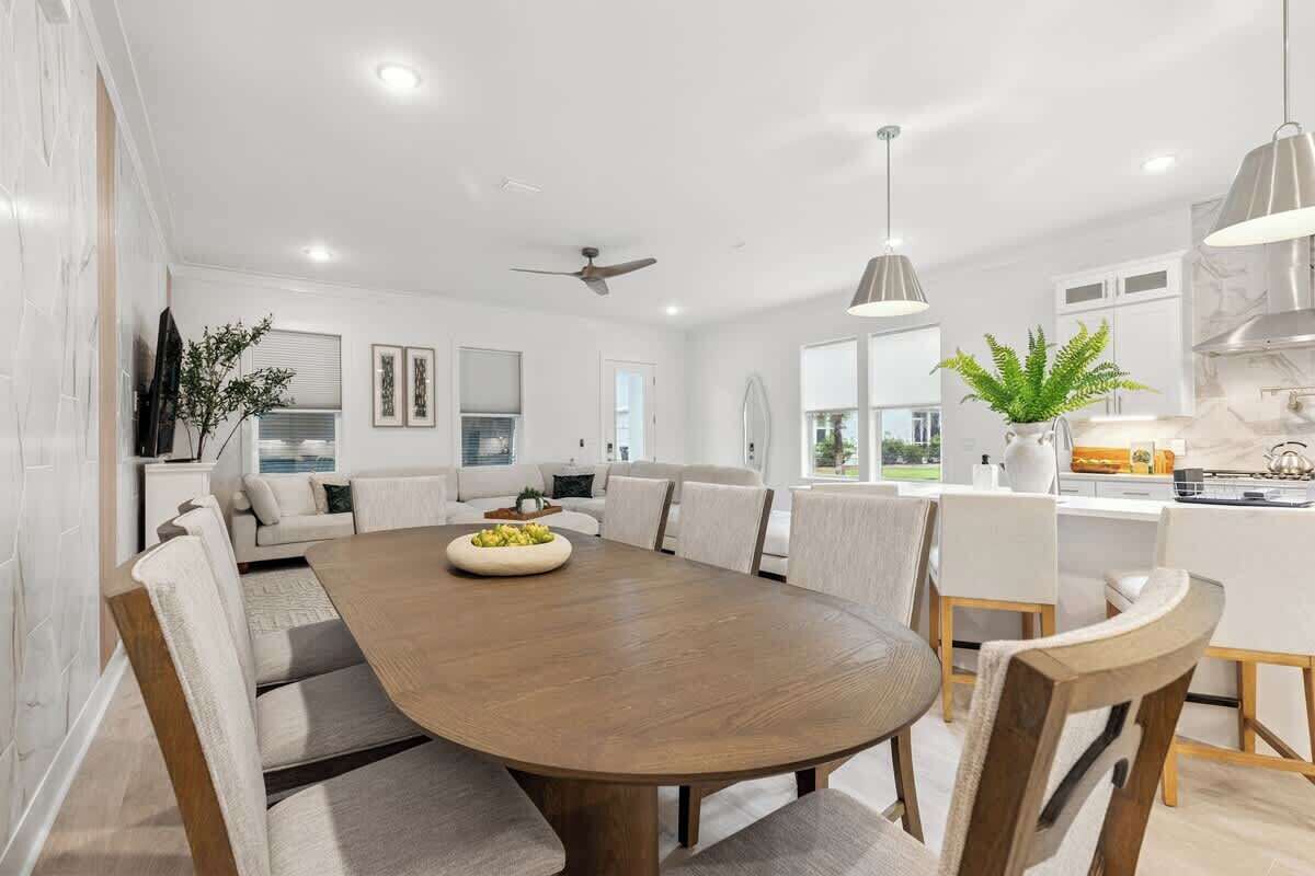 A modern kitchen with white cabinetry, a central island, and pendant lighting.