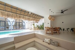 Deluxe Villa, Patio, Pool View | Living area