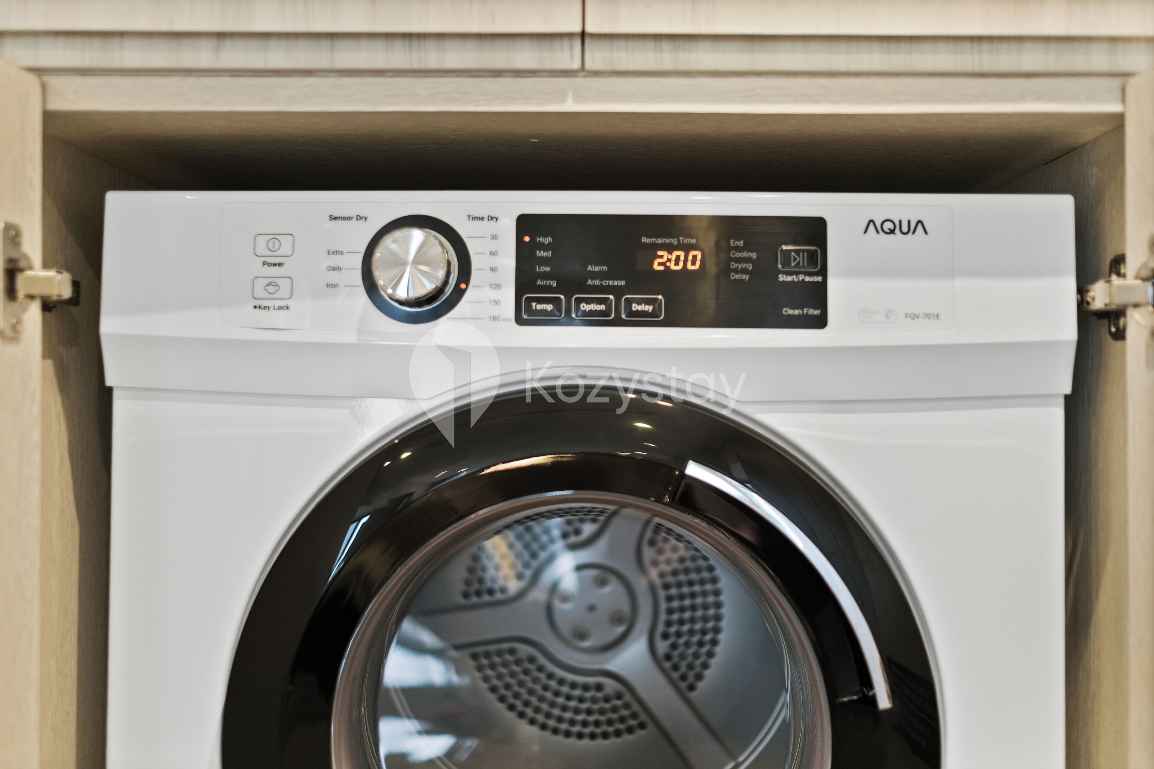 A front view of a front-loading washing machine with a digital display and control panel.