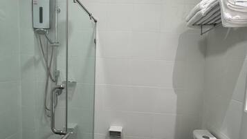 A bathroom with a glass-enclosed shower, a white toilet, and a sink.