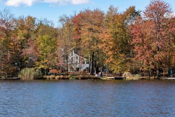 Our Lakefront Home – here’s our cozy home from across the water. Enjoy direct lakefront access with our private dock – take out our kayaks or boat to enjoy the water!