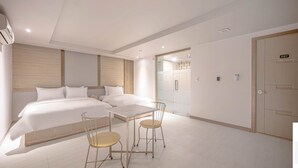 A modern hotel room with two beds, a small table with chairs, and a door marked with the number 307. - Zzam Hotel (Jeonju)