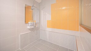 A modern bathroom with a shower, a mirror, and a vanity with toiletries. - Zzam Hotel (Jeonju)