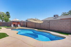 A swimming pool with a brick wall, a patio area, and a covered seating area. - Near Golf Courses: Poolside Paradise in Yuma! (Yuma)