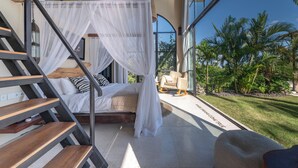 A bedroom with a bed, white canopy, and a view of the outdoors. - The Castle (Pecatu)