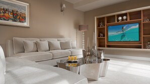 A modern living room with a large flat-screen TV, a sofa, a coffee table, and a painting on the wall. - Villa in Vabriga with Pool and Private Garden (Vabriga)