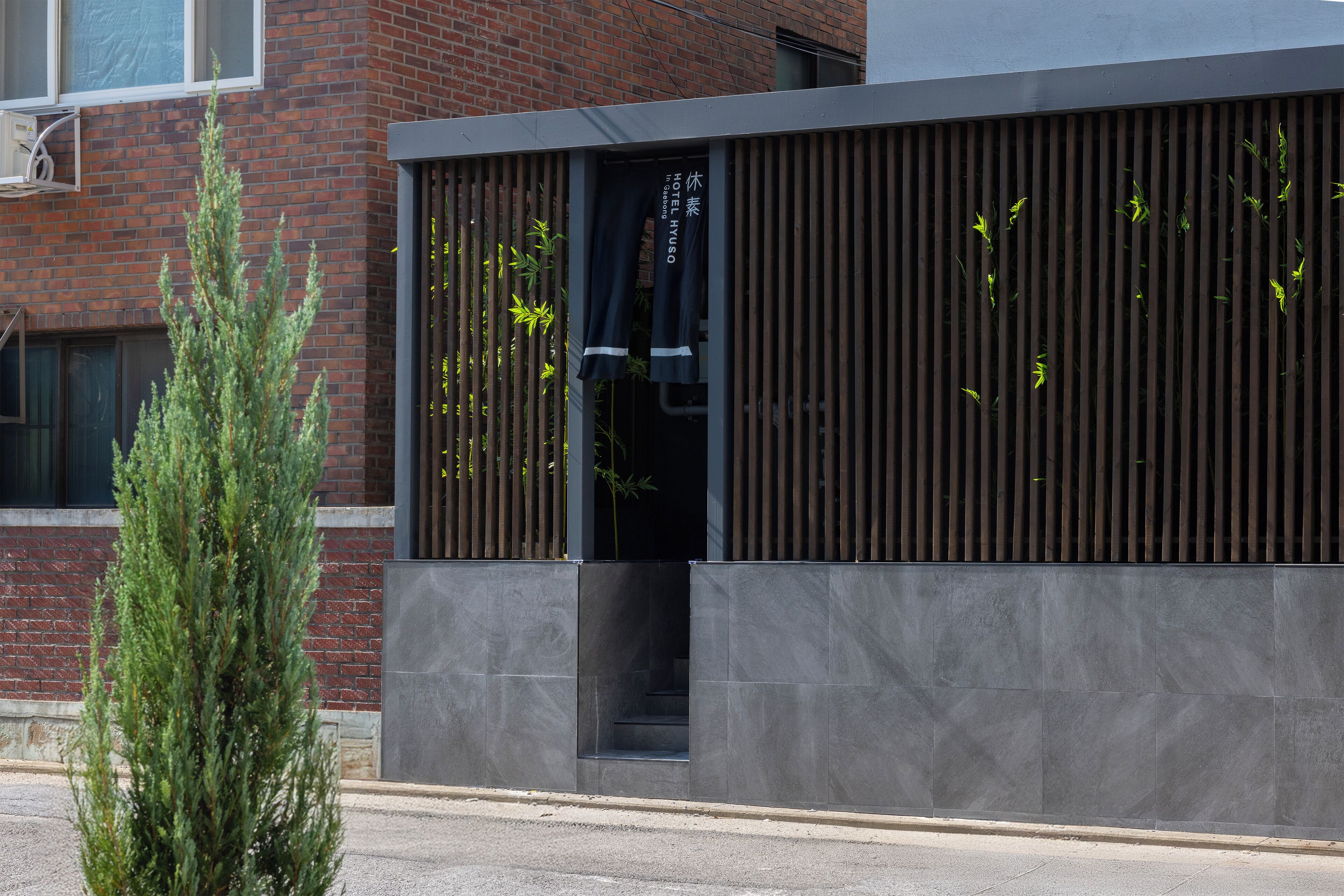 A modern building with a brick facade and a metal entrance.