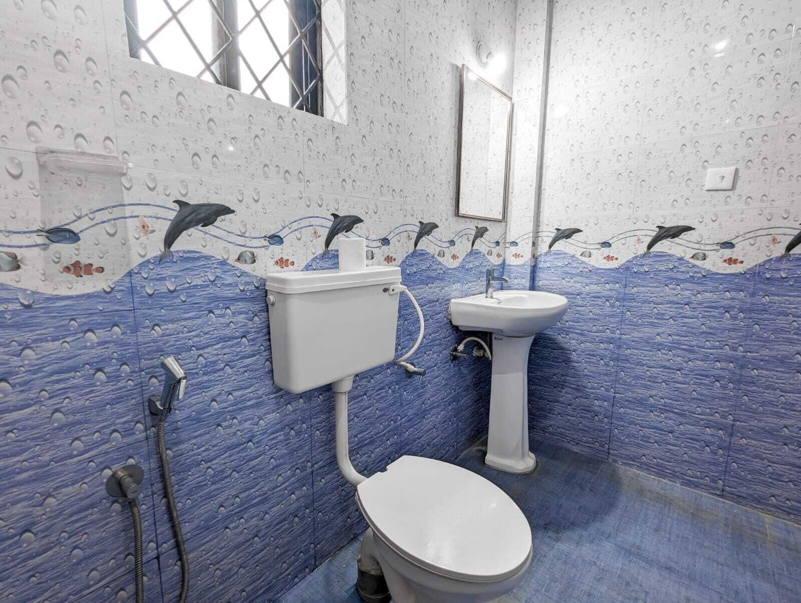 A bathroom with a toilet, sink, and shower.