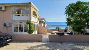 A two-story building with a stone facade, a balcony, and a view of the sea and mountains. - 2 bedroom awesome apartment in Vir (Vir)